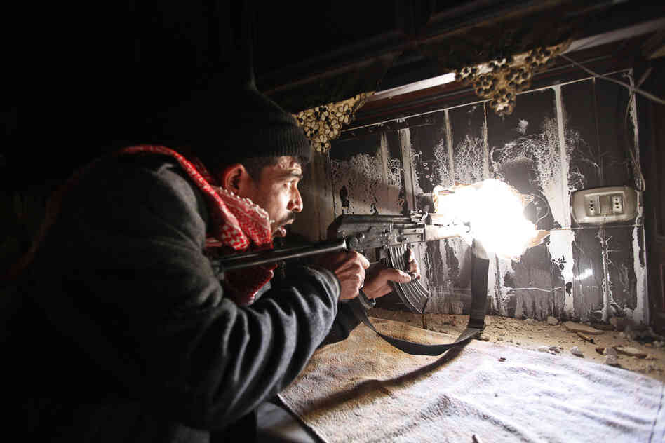 All of the photos in this slideshow were taken by Nour Kelze but published under the pseudonym Zain Karam. Kelze recently decided to begin publishing her photos under her real name. Here, a Free Syrian Army fighter takes up position inside a burned-out room in Aleppo, Syria, in November 2012.