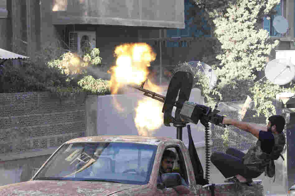 A member of the Free Syrian Army opens fire with a machine gun during clashes with Syrian army forces in Aleppo in September.