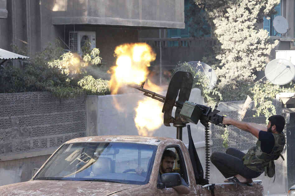 A member of the Free Syrian Army opens fire with a machine gun during clashes with Syrian army forces in Aleppo in September.