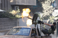 A member of the Free Syrian Army opens fire with a machine gun during clashes with Syrian army forces in Aleppo in September.