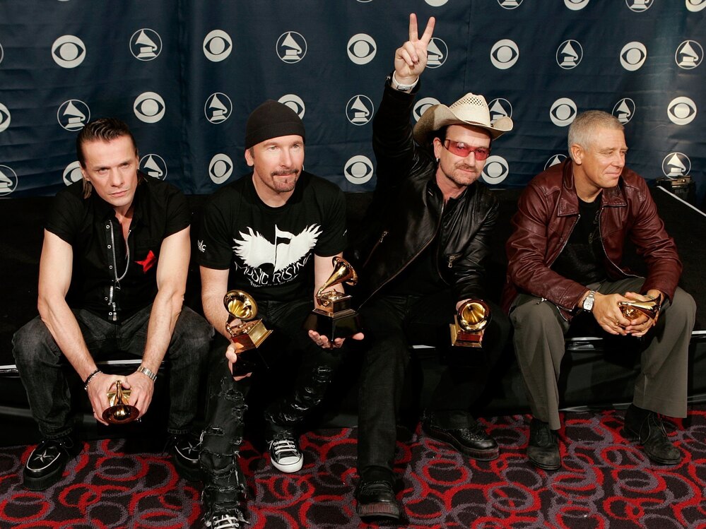 U2's Larry Mullens Jr. (from left), the Edge, Adam Clayton and Bono pose with their Album of the Year at the 48th Annual Grammy Awards.