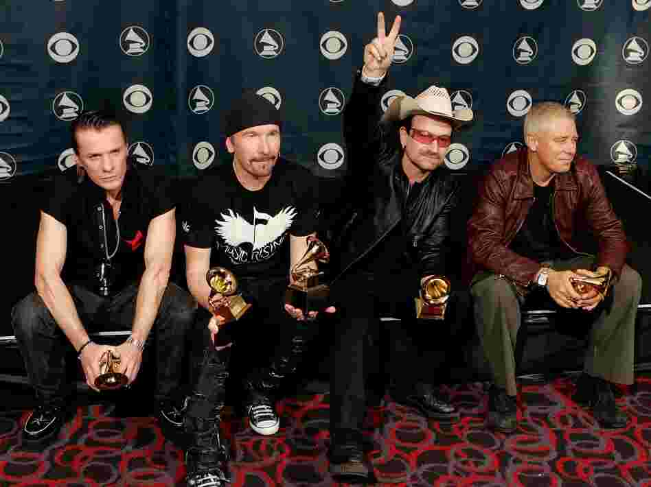 U2's Larry Mullens Jr. (from left), the Edge, Adam Clayton and Bono pose with their Album of the Year at the 48th Annual Grammy Awards.