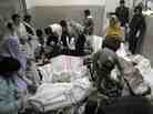 Rescue teams attend the bodies of victims who died in a marketplace bomb blast in Quetta, Pakistan, on Saturday.