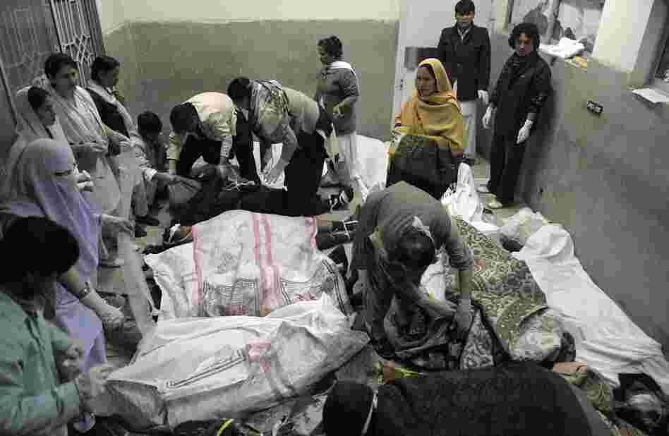 Rescue teams attend the bodies of victims who died in a marketplace bomb blast in Quetta, Pakistan, on Saturday.