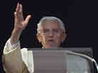 Pope Benedict XVI acknowledges a cheering crowd of faithful and pilgrims during the Angelus prayer from the window of his apartments at the Vatican on Sunday.