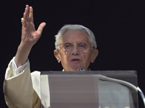 Pope Benedict XVI acknowledges a cheering crowd of faithful and pilgrims during the Angelus prayer from the window of his apartments at the Vatican on Sunday.