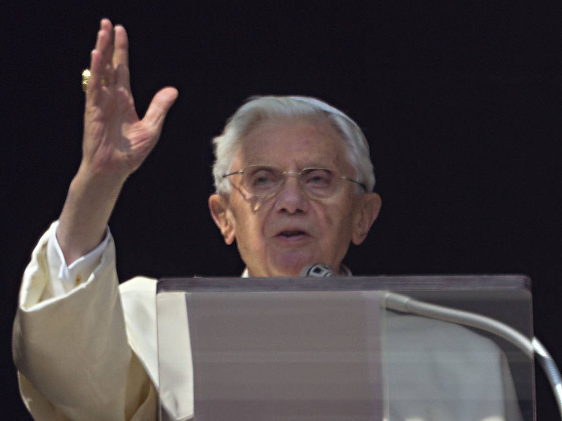 Pope Benedict XVI acknowledges a cheering crowd of faithful and pilgrims during the Angelus prayer from the window of his apartments at the Vatican on Sunday.