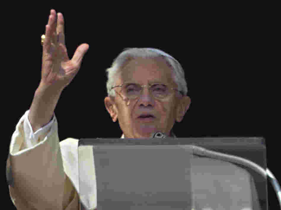 Pope Benedict XVI acknowledges a cheering crowd of faithful and pilgrims during the Angelus prayer from the window of his apartments at the Vatican on Sunday.