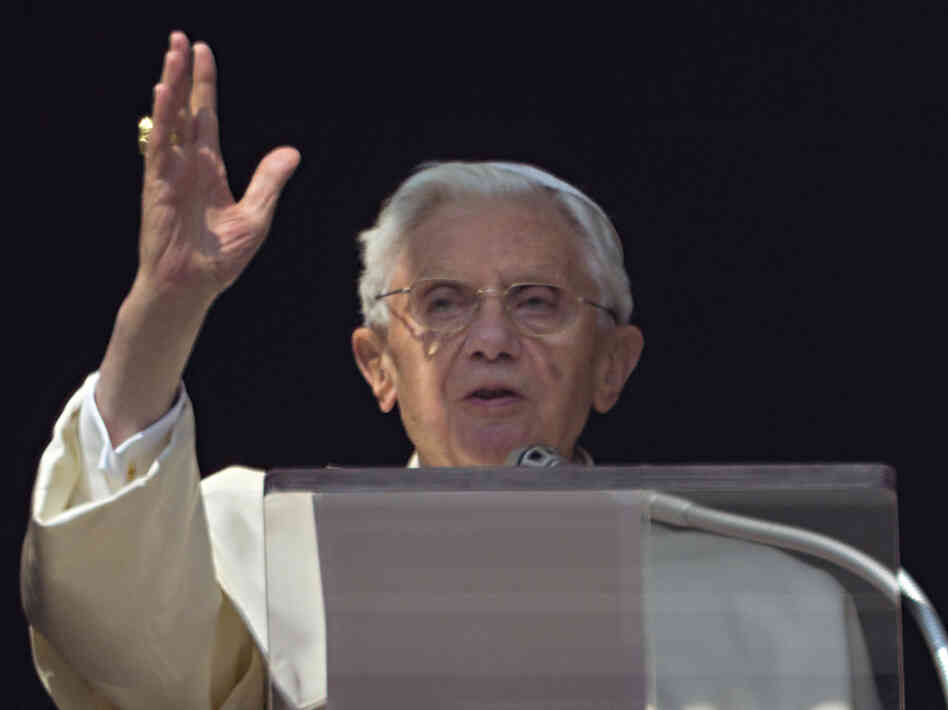 Pope Benedict XVI acknowledges a cheering crowd of faithful and pilgrims during the Angelus prayer from the window of his apartments at the Vatican on Sunday.
