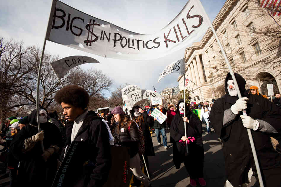 The Grim Reaper was a common theme, ranging from a costumed group to a cutout on a sign that read, "The only steady job on a dying planet will be mine"