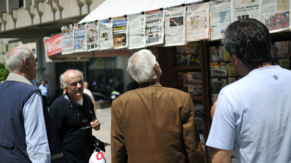 People read newspaper headlines in Athens. In 2009, there were 39 national dailies, 23 national Sunday papers, 14 national weekly papers and dozens of TV and radio stations for a population of 11 million.