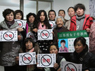 Some former prisoners of re-education through labor camps and their supporters hold signs in Beijing declaring, "No Re-education Through Labor." Popular opposition to the camps has grown as China's state-run media has highlighted particularly egregious cases. Some former prisoners of re-education through labor camps and their supporters hold signs in Beijing declaring, "No Re-education Through Labor." Popular opposition to the camps has grown as China's state-run media has highlighted particularly egregious cases.