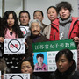 Some former prisoners of re-education through labor camps and their supporters hold signs in Beijing declaring, "No Re-education Through Labor." Popular opposition to the camps has grown as China's state-run media has highlighted particularly egregious cases. Some former prisoners of re-education through labor camps and their supporters hold signs in Beijing declaring, "No Re-education Through Labor." Popular opposition to the camps has grown as China's state-run media has highlighted particularly egregious cases.