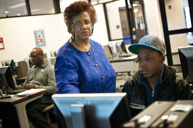 Part-time librarian Janet Sims-Wood, 67, helps student Andre Williams navigate the online catalogue at the Accokeek Library at Prince George's Community College in Largo, Md.