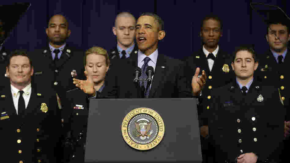 President Obama, accompanied by emergency responders — workers the White House says could be affected if state and local governments lose federal money as a result of budget cuts — speaks in the Eisenhower Executive Office building in Washington on Tuesday.