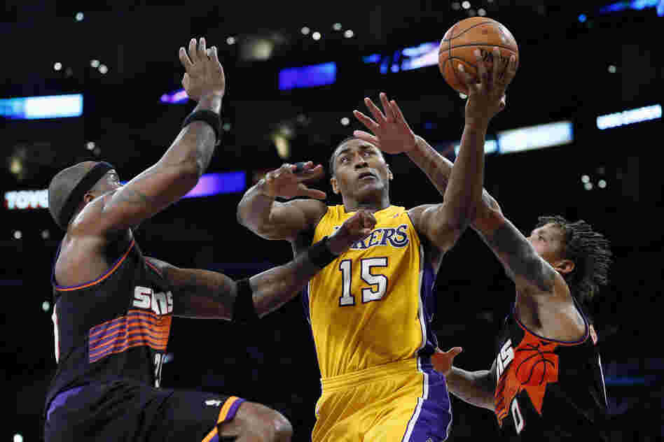 The Los Angeles Lakers' Metta World Peace (center), formerly known as Ron Artest, has been suspended 12 times for displays of violence during his career. Here, he is fouled during a recent game against the Phoenix Suns.