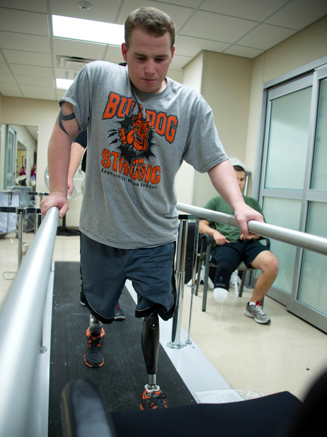 Jeffries takes his first steps on prosthetic legs during what he described as an exhausting and painful physical therapy session at Walter Reed National Military Medical Center in Bethesda, Md., in November 2012, less than two months after the roadside bombing.