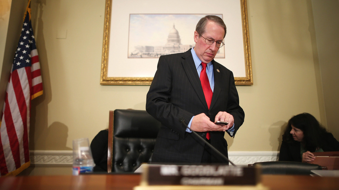 Rep. Bob Goodlatte, R-Va., checks his phone before a hearing on Capitol Hill in September.