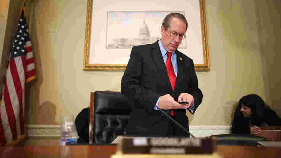Rep. Bob Goodlatte, R-Va., checks his phone before a hearing on Capitol Hill in September.