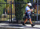 A mailman for the U.S. Postal Service delivers mail on November 15, 2012 in Miami, Florida.