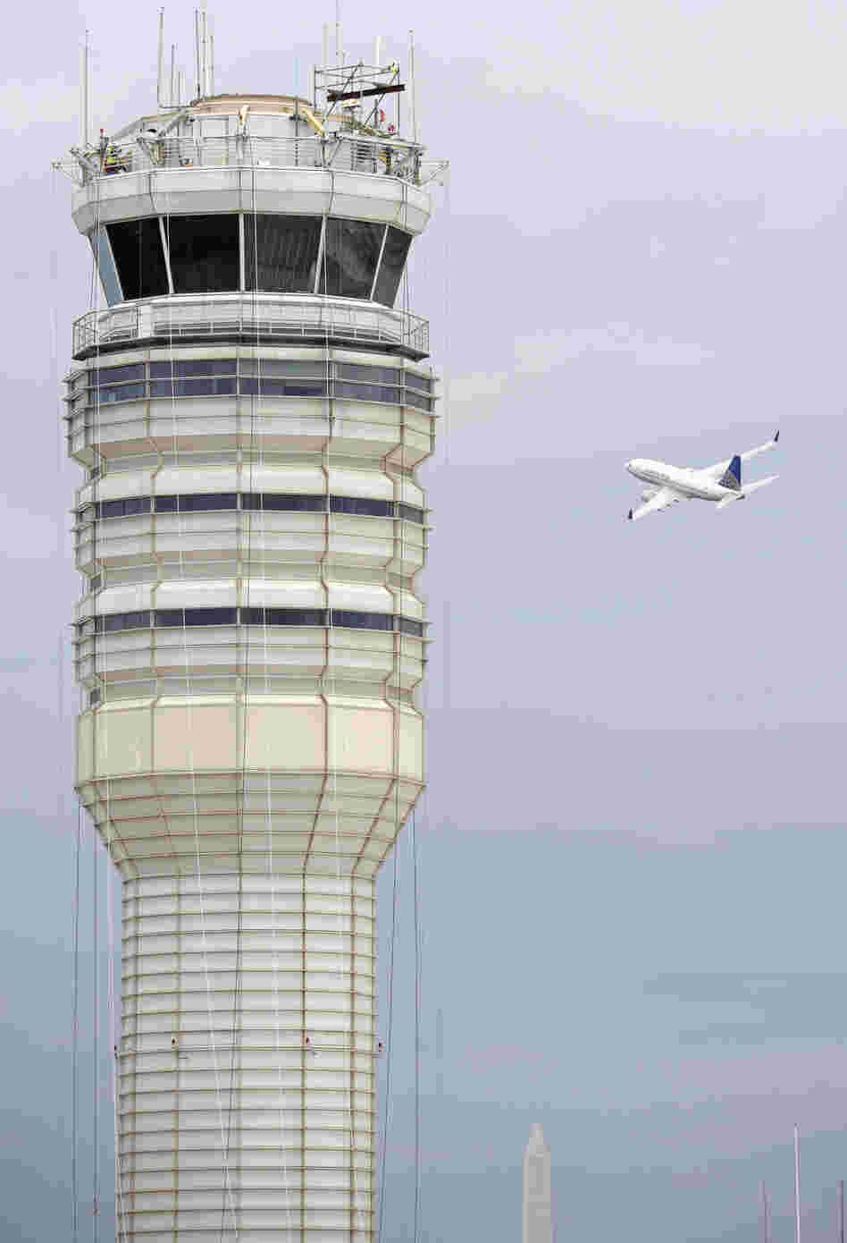 A passenger jet flies past the FAA control tower at Washington's Ronald Reagan National Airport in 2011.
