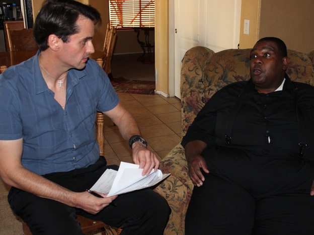 Mercy Care case manager Dave Oxford (left) checks in with his client, Joseph Ford.