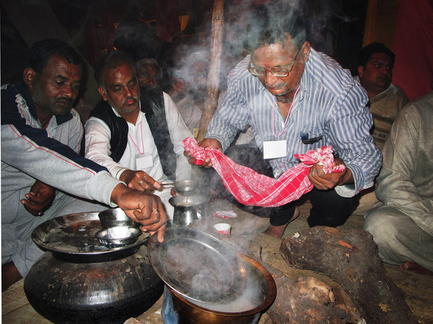 Followers of Kamal prepare tea during the Kumbh Mela.