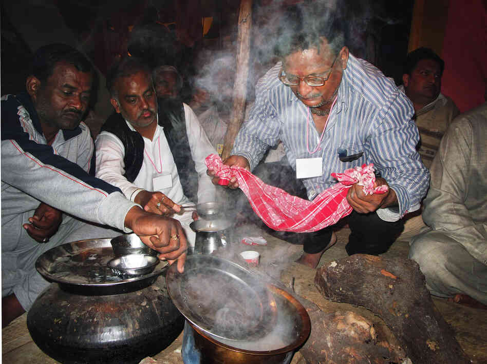 Followers of Kamal prepare tea during the Kumbh Mela.