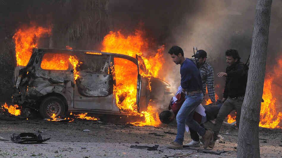 Syrian security agents carry a body following a huge car bombing in Damascus on Thursday. More than 50 people were killed in one of the worst attacks in the capital since the uprising began in 2011. Syrian security agents carry a body following a huge car bombing in Damascus on Thursday. More than 50 people were killed in one of the worst attacks in the capital since the uprising began in 2011.