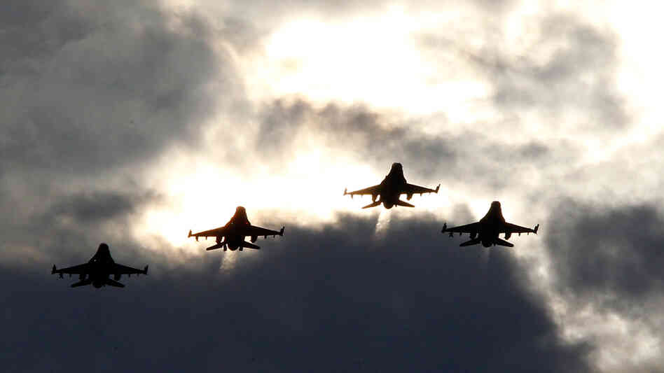 Four F-16s from the 77th Fighter Squadron of Shaw Air Force Base fly over Darlington Raceway before a NASCAR race in Darlington, S.C., in May 2012.