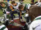 Tim Tebow, center, leads a prayer after the Jets' loss to San Diego Chargers on December 23.
