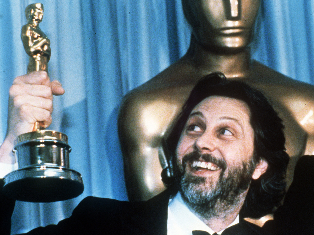 David Putnam, producer of Chariots of Fire, holds up his Oscar after the movie won best picture in 1982.