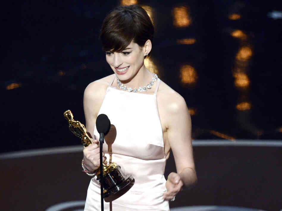 Anne Hathaway accepts the Oscar for best supporting actress in Les Miserables.