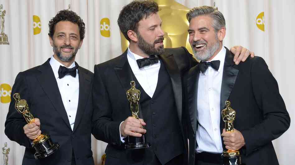 Ben Affleck (center), George Clooney (right) and Grant Heslov celebrate in the press room after winning the Oscar for best picture for Argo.