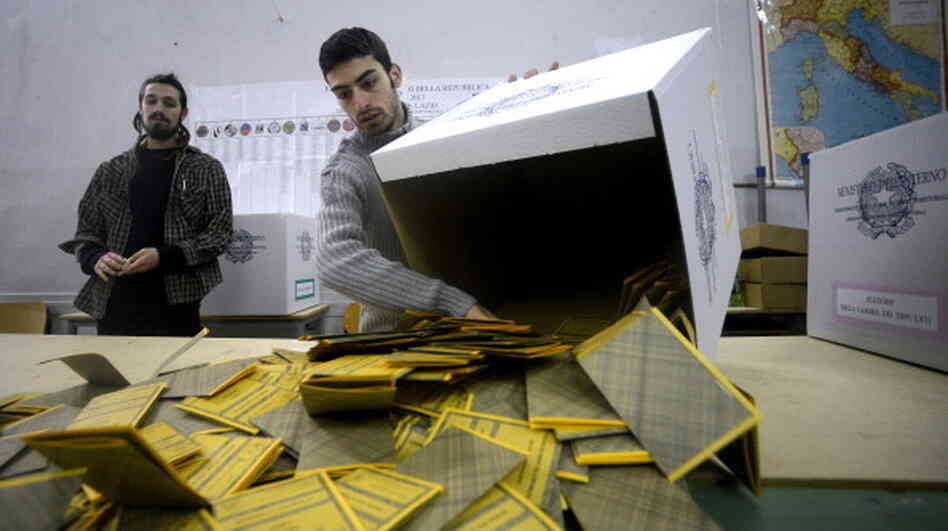 Workers open ballots in a polling station in Rome on Tuesday following Italy's general elections. The initial results showed a close race with no clear-cut winner, a development that made financial markets jumpy.