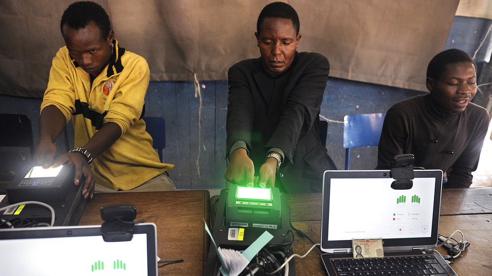 Kenyan authorities are trying to guard against fraud and violence when they hold a presidential election on March 4. Here, voters register on biometric equipment last December in Nairobi.