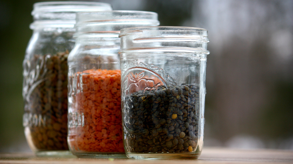 Three types of lentils in jars