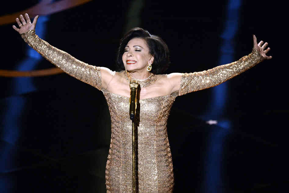 The legendary Shirley Bassey makes an appearance to sing the theme song from the James Bond classic "Goldfinger."