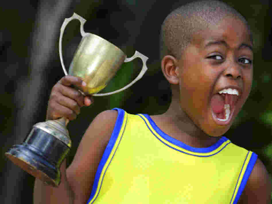 A young child shouts with joy after winning his sporting event. A young child shouts with joy after winning his sporting event.