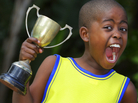 A young child shouts with joy after winning his sporting event. A young child shouts with joy after winning his sporting event.