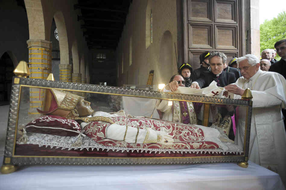 Pope Benedict XVI stands by the salvaged remains of Pope Celestine V, in the 13th-century Santa Maria di Collemaggio Basilica, in L'Aquila, Italy, in 2009.