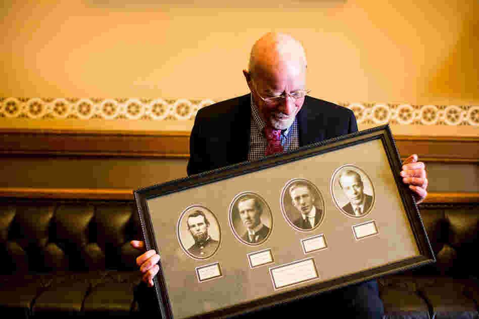 Risser holds a frame with photos of four generations of legislators in his family. His father, Fred E. Risser was a state senator; his grandfather, Ernest Warner, was an assembly member; and his great-grandfather, Clement Warner, was a state senator and assembly member following the Civil War.