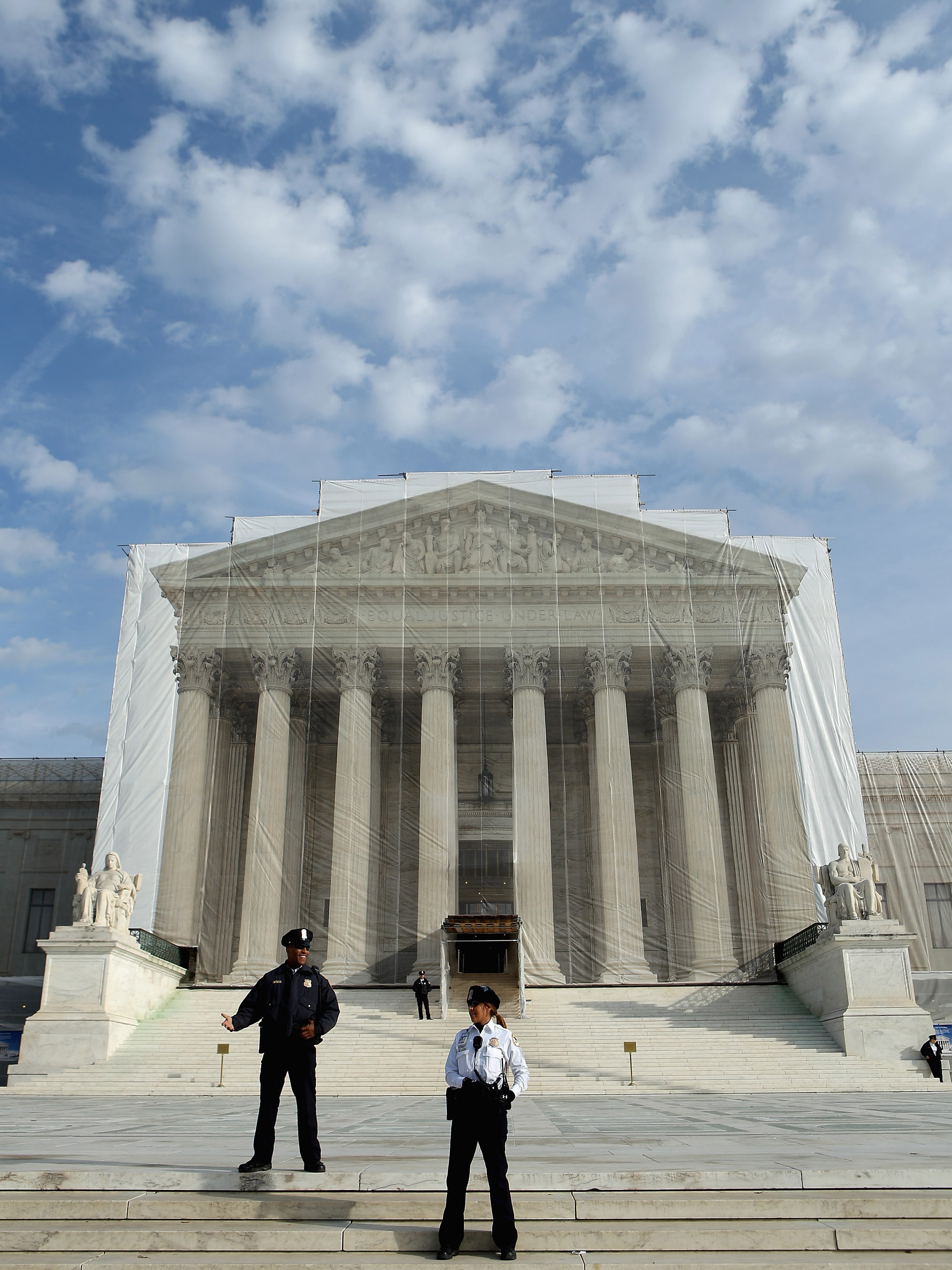 U.S. Supreme Court Police officers stand on the steps in front of the court building in November. (Image credit: Getty Images)