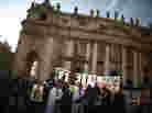A church group prepares to pray for Pope Benedict XVI on the steps of St. Peter's Basilica on Tuesday.