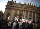 A church group prepares to pray for Pope Benedict XVI on the steps of St. Peter's Basilica on Tuesday.