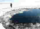 A circular hole in the ice of Chebarkul Lake, where the Chelyabinsk meteor reportedly struck on Feb. 15.