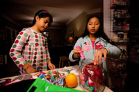 Celedonia (left) and Anita pick a few pieces of candy to add to their lunches. The house rule is that they can eat no more than two to three pieces a day.