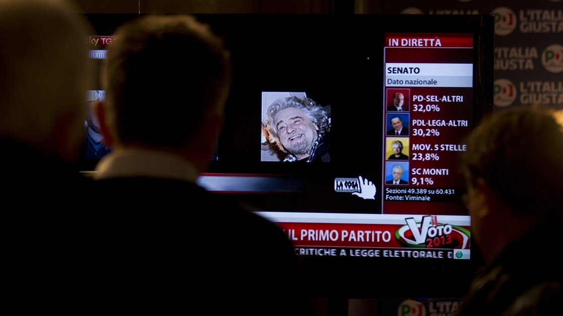 The Five Star Movement's Beppe Grillo is shown on TV Monday at the Democratic Party press center in Rome. The prospect of political paralysis hung over Italy as election results showed the upstart protest campaign making stunning inroads, and mainstream forces of center-left and center-right wrestling for control of Parliament's two houses.