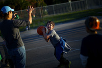 Henry Condes, 7, practices shooting a basketball. His mother, Yvonne, spends most afternoons ferrying her two boys from one sporting activity to another.