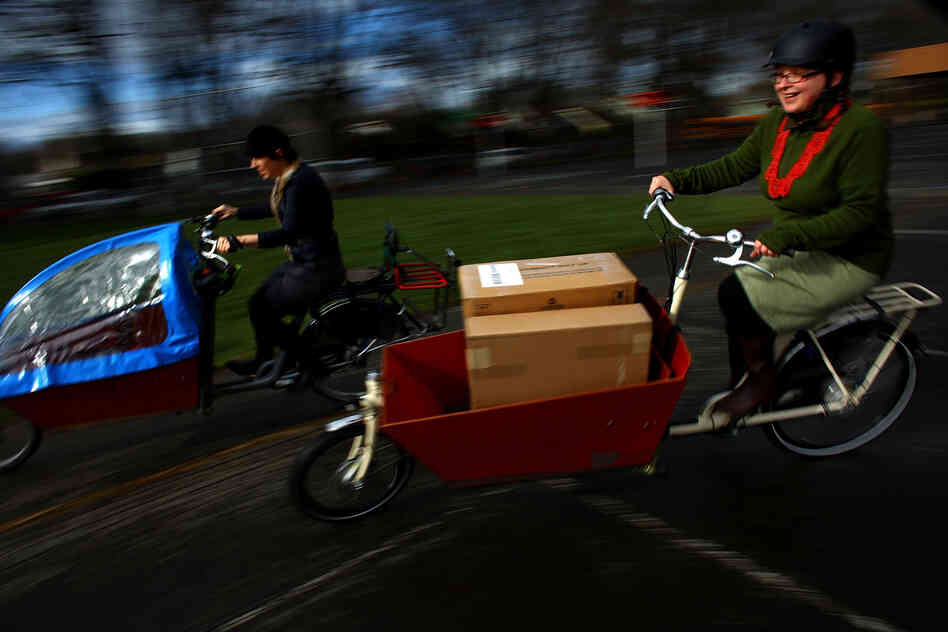 Emily Finch (left), a mother of six, and Martina Fahrner, co-owner of Clever Cycles in Portland, Ore., ride Bakfiets Cargobikes. Finch traded in her Chevy Suburban for her bicycle, which she uses for her daily errands.